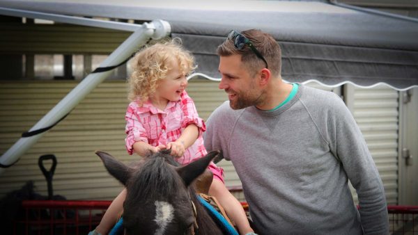 girl on pony ride with dad