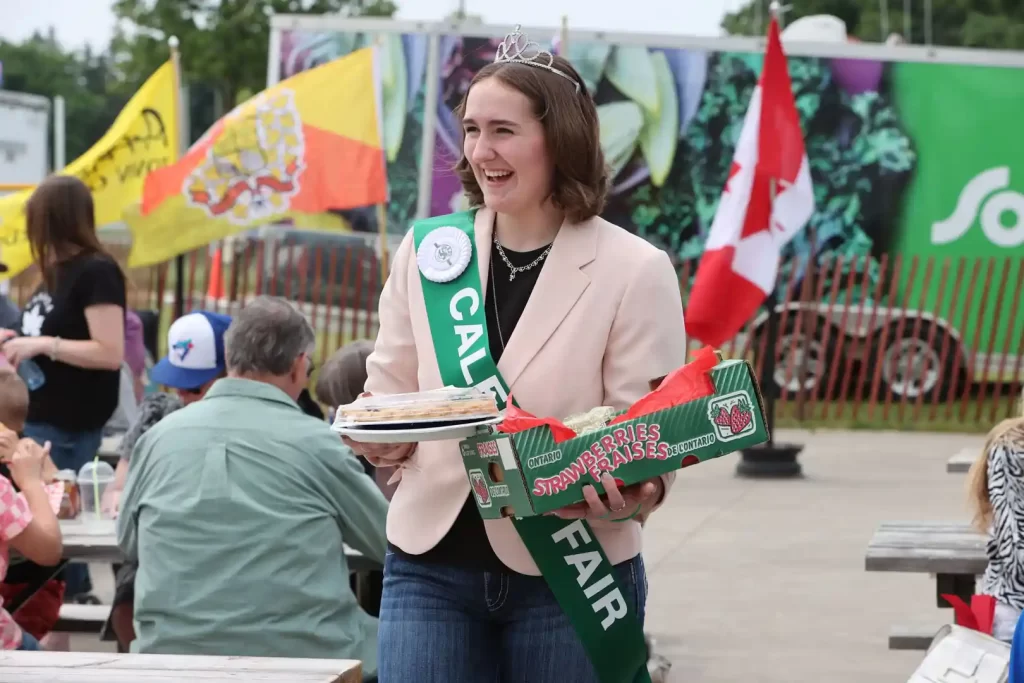 Ambassador Nikki Intranuovo showing auction items at the Backed Goods Sale